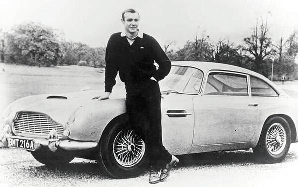 Sean Connery as James Bond, poses with Aston Martin DB5 - 1965