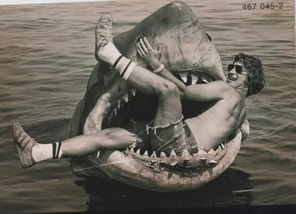 Steven Spielberg sits in the mechanical shark used in JAWS